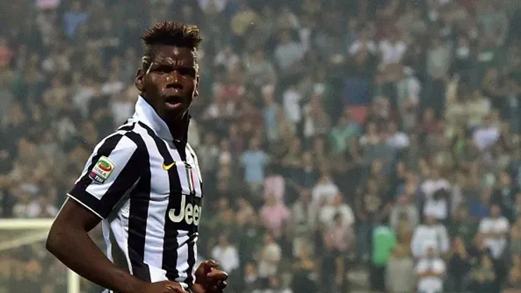 Juventus French midfielder Paul Labile Pogba celebrates after scoring a goal during the Serie A football match between Sassuolo and Juventus at the Mapei Stadium in Reggio Emilia on October 18, 2014 . AFP PHOTO / GIUSEPPE CACACE (Photo credit should read GIUSEPPE CACACE/AFP/Getty Images)