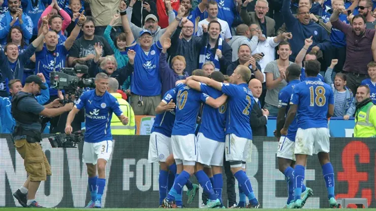 Leicester City players celebrates after Leonardo Ulloa, hidden, scored a penalty to beat Manchetser United 5-3 during the English Premier League soccer match between Leicester City and Manchester United at King Power Stadium, in Leicester, England, Sunday, Sept. 21, 2014. (AP Photo/Rui Vieira)

