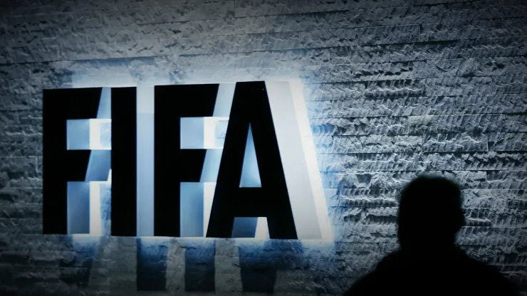 FILE – In this Oct. 29, 2007 file photo, a person stands next to the FIFA logo at the FIFA headquarter in Zurich, Switzerland. The Swiss Federal Office of Justice said six soccer officials have been arrested and detained pending extradition at  the request of U.S. authorities ahead of the FIFA congress in Zurich. In a statement Wednesday, May 27, 2015, the FOJ said U.S. authorities suspect the officials of having received paid bribes totaling millions of dollars.  (Steffen Schmidt/Keystone via AP, File)
