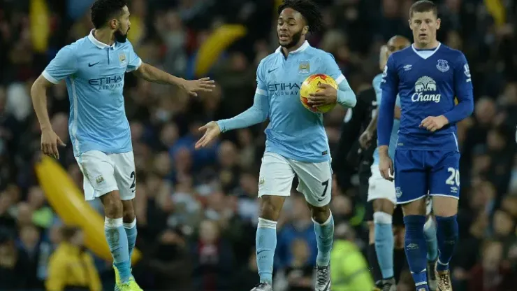 Manchester City's midfielder Raheem Sterling (C) celebrates with defender Gael Clichy (L) after Kevin De Bruyne scored the team's second goal against Everton. Photo credit: AFP.