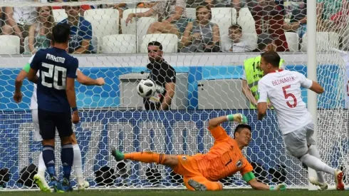 Japan booed off but reach last 16 despite Poland loss