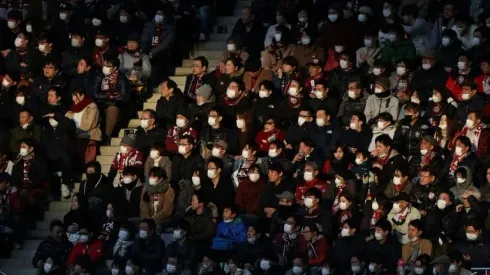 Olympics 'continuing as planned' but virus halts Japanese football