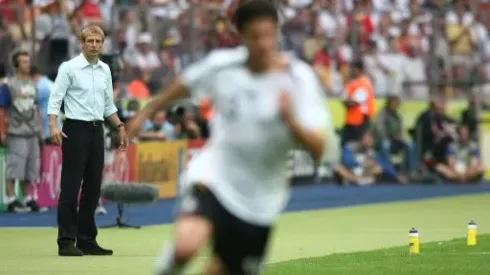 Jurgen Klinsmann, Germany coach looks on as Michael Ballack attacks