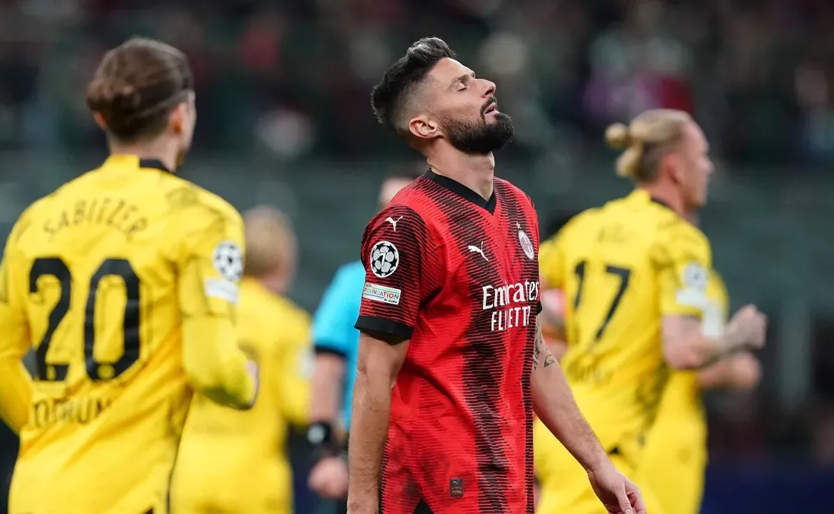 Dortmund into Champions League knockouts with win at Milan