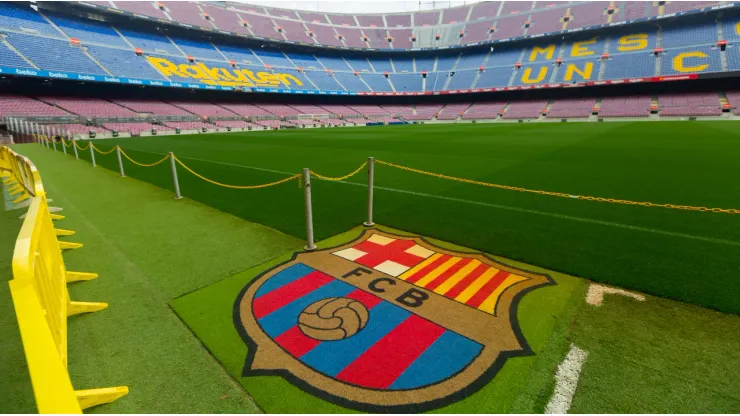 BARCELONA, SPAIN – MAY 23, 2021: Football Club Barcelona emblem on grass of empty Camp Nou stadium field

