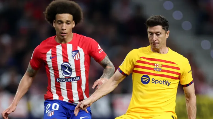 Robert Lewandowski of FC Barcelona is challenged by Axel Witsel of Atletico Madrid during the LaLiga EA Sports match between Atletico Madrid and FC Barcelona at Civitas Metropolitano Stadium on March 17, 2024 in Madrid, Spain.