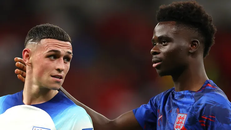 Phil Foden of England is congratulated by Bukayo Saka after their 3-0 victory in the FIFA World Cup Qatar 2022 Group B match between Wales and England at Ahmad Bin Ali Stadium on November 29, 2022 in Doha, Qatar.