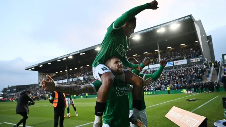 Lewis Gibson, Matthew Sorinola and Muhamed Tijani of Plymouth Argyle celebrate victory after the Emirates FA Cup Fourth Round match between Plymouth Argyle and Liverpool at Home Park on February 09, 2025 in Plymouth, England.