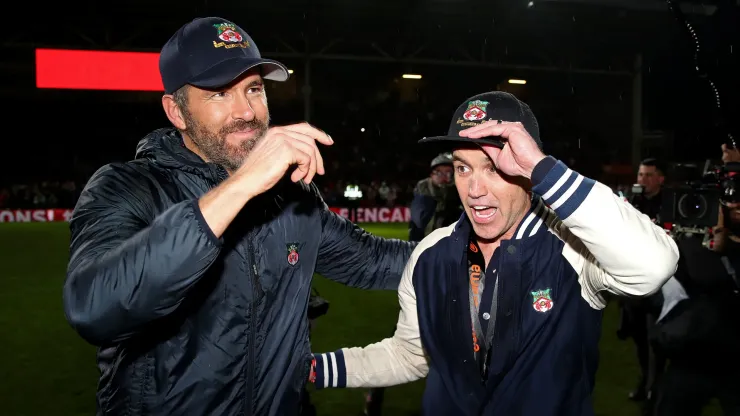 Ryan Reynolds and Rob McElhenney, Owners of Wrexham embrace after Wrexham win the Vanarama National League and are promoted to the English Football League after victory in the Vanarama National League match between Wrexham and Boreham Wood at Racecourse Ground on April 22, 2023 in Wrexham, Wales.