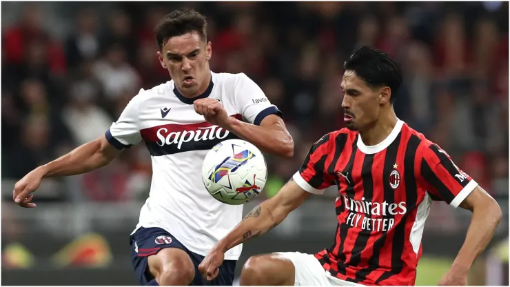 Tijjani Reijnders of AC Milan is challenged by Nikola Moro of Bologna
