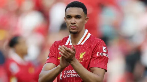 Trent Alexander-Arnold of Liverpool applauds the fans after the draw in the Premier League match between Liverpool FC and Arsenal FC at Anfield on May 11, 2025 in Liverpool, England.
