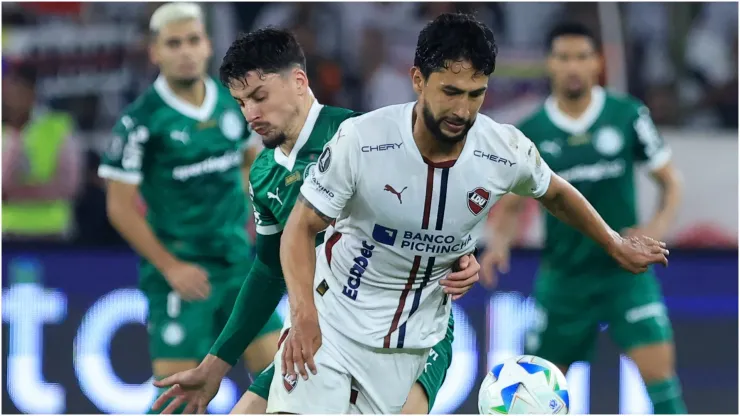 Jeison Medina of LDU de Quito is challenged by Joaquin Piquerez of Palmeiras