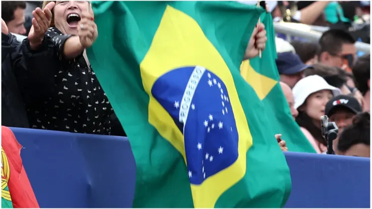 Fans wave the national flag of Brazil