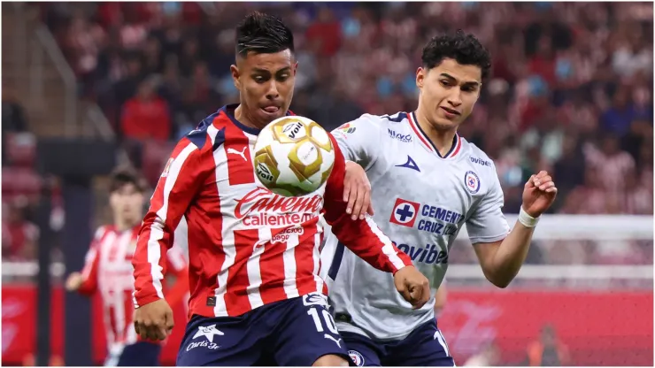 Efrain Alvarez of Chivas competes for the ball with Angel Marquez of Cruz Azul
