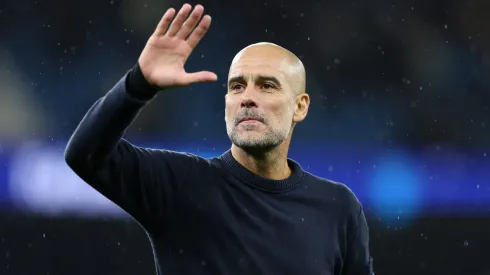 Pep Guardiola, Manager of Manchester City, waves to the fans.