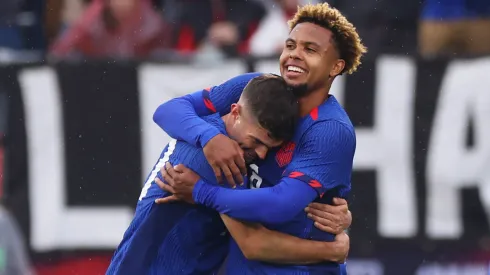 Weston McKennie #8 of the United States is and Christian Pulisic #10