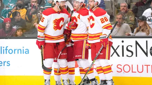 SAN JOSE, CALIFORNIA - APRIL 07: Matthew Tkachuk #19 of the Calgary Flames is congratulated by Johnny Gaudreau #13, Noah Hanifin #55 and Elias Lindholm #28 after Tkachuk scored a goal against the San Jose Sharks during the first period of an NHL hockey game at SAP Center on April 07, 2022 in San Jose, California. (Photo by Thearon W. Henderson/Getty Images)