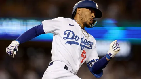 LOS ANGELES, CALIFORNIA - MAY 13: Mookie Betts #50 of the Los Angeles Dodgers runs out an RBI double to score Austin Barnes #15, to tie the game 2-2 with the Philadelphia Phillies, during the third inning at Dodger Stadium on May 13, 2022 in Los Angeles, California. (Photo by Harry How/Getty Images)