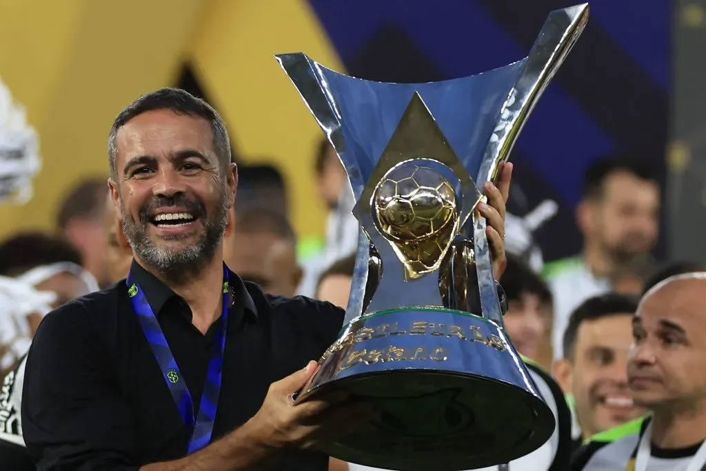 RIO DE JANEIRO, BRAZIL – DECEMBER 08: Artur Jorge, head coach of Botafogo poses with the champions trophy after a match between Botafogo and Sao Paulo as part of Brasileirao 2024 at Estadio Olímpico Nilton Santos on December 08, 2024 in Rio de Janeiro, Brazil. (Photo by Buda Mendes/Getty Images)