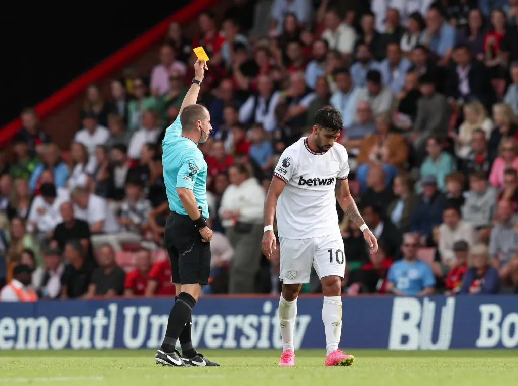 BOURNEMOUTH, ENGLAND – AUGUST 12: Referee Peter Bankes shows a yellow card to Lucas Paqueta of West Ham United during the Premier League match between AFC Bournemouth and West Ham United at Vitality Stadium on August 12, 2023 in Bournemouth, England. (Photo by Henry Browne/Getty Images)