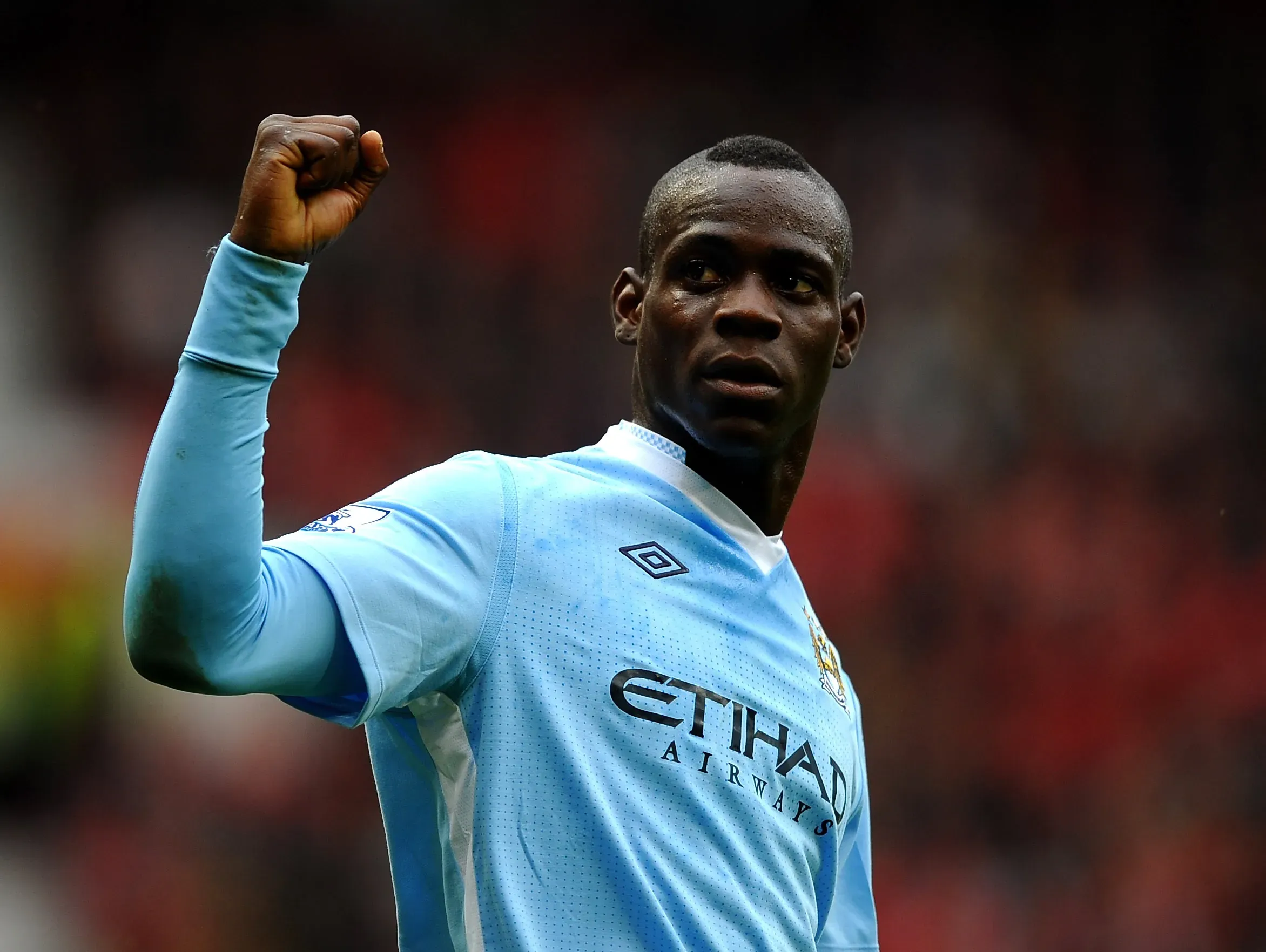 MANCHESTER, ENGLAND – OCTOBER 23: Mario Balotelli of Manchester City celebrates scoring his team’s second goal during the Barclays Premier League match between Manchester United and Manchester City at Old Trafford on October 23, 2011 in Manchester, England. (Photo by Laurence Griffiths/Getty Images)
