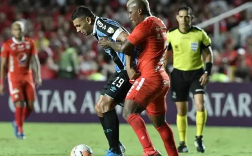 Diego Souza é puxado por Marlon Torres. Foto: Getty Images