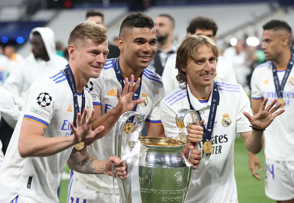 Toni Kroos, Casemiro and Luka Modric of Real Madrid celebrate with the UEFA Champions League trophy after their sides victory during the UEFA Champions League final match between Liverpool FC and Real Madrid at Stade de France on May 28, 2022 in Paris, France. – Photo by Julian Finney/Getty Images