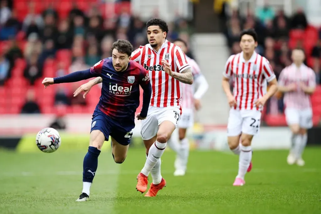 STOKE ON TRENT, ENGLAND – APRIL 06: Mikey Johnston of West Bromwich Albion is challenged by Ki-Jana Hoever of Stoke City during the Sky Bet Championship match between Stoke City and West Bromwich Albion at Bet365 Stadium on April 06, 2024 in Stoke on Trent, England. (Photo by Jess Hornby/Getty Images)