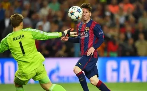 Messi chips Neuer as he scores in the game (Getty).