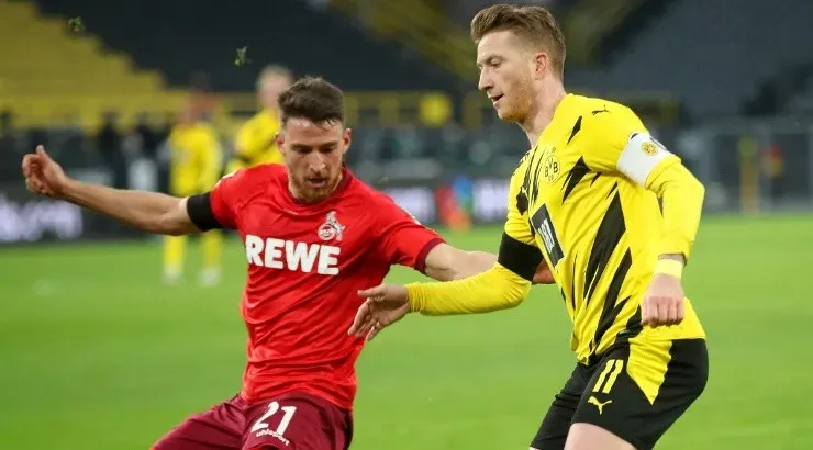 Marco Reus of Borussia Dortmund (right) is closed down by Salih Oezcan of Koln (left). (Getty)
