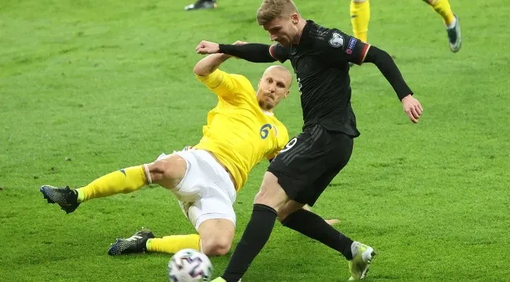 Timo Werner (right) of Germany battles for the ball with Vlad Chririches (left) of Romania. (Getty)