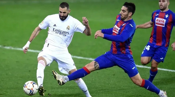 Pedro Bigas of Eibar (right) battles for possession with Karim Benzema of Real Madrid (left). (Getty)
