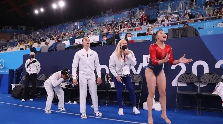 Sunisa Lee, Simone Biles, coach Cecile Landi, and Jordan Chiles of Team United States react during the Women’s Team Final on day four of the Tokyo 2020 Olympic Games (Getty)