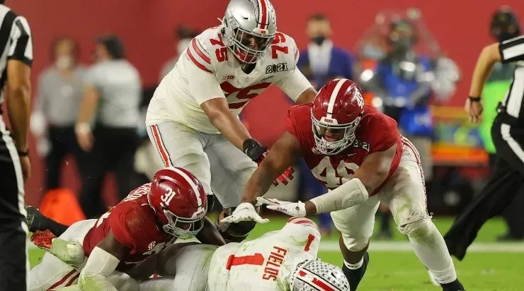 Phidarian Mathis #48 and Will Anderson Jr. #31 of the Alabama Crimson Tide sack Justin Fields #1 of the Ohio State Buckeyes during the fourth quarter of the College Football Playoff National Championship game at Hard Rock Stadium on January 11, 2021 in Miami Gardens, Florida. (Getty)