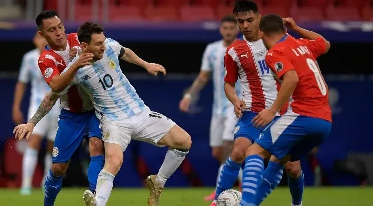 Lionel Messi of Argentina competes for the ball with Ángel Cardozo (L), Santiago Arzamendia and Richard Sanchez (R) of Paraguay (Getty)