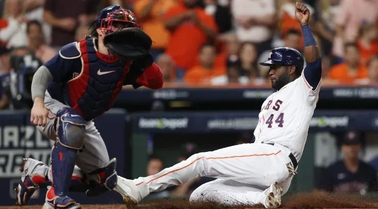 Yordan Alvarez #44 of the Houston Astros safely scores (Photo by Elsa/Getty Images)