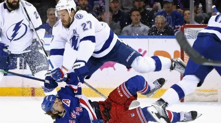 Artemi Panarin #10 of the New York Rangers is checked by Ryan McDonagh #27 of the Tampa Bay Lightning (Photo by Bruce Bennett/Getty Images)