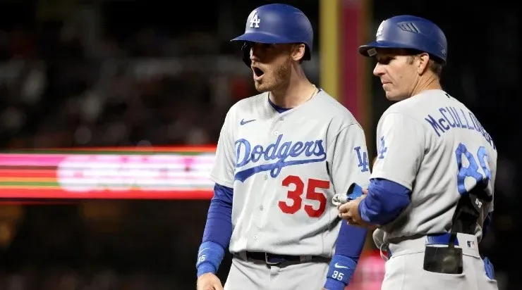 Cody Bellinger #35 of the Los Angeles Dodgers celebrates with first base coach Clayton McCullough #86 his RBI single (Photo by Harry How/Getty Images)