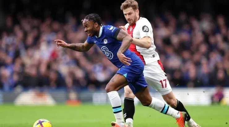 Raheem Sterling of Chelsea runs with the ball whilst under pressure from Stuart Armstrong of Southampton (Photo by Julian Finney/Getty Images)