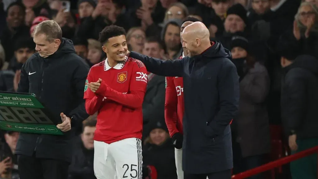 Erik ten Hag speaks with Jadon Sancho before he comes on as a substitute during the Carabao Cup Semi Final 2nd Leg match between Manchester United and Nottingham Forest at Old Trafford on February 01, 2023 in Manchester, England.