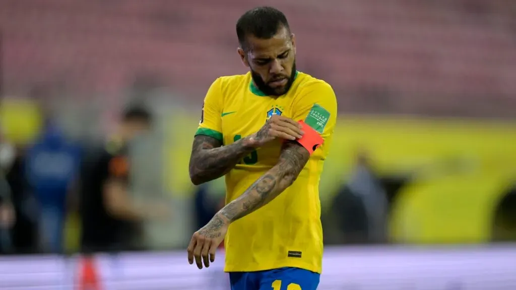 Dani Alves of Brazil fixes his captain’s armband during a match between Brazil and Peru as part of South American Qualifiers for Qatar 2022 at Arena Pernambuco on September 09, 2021 in Recife, Brazil. (Photo by Pedro Vilela/Getty Images)