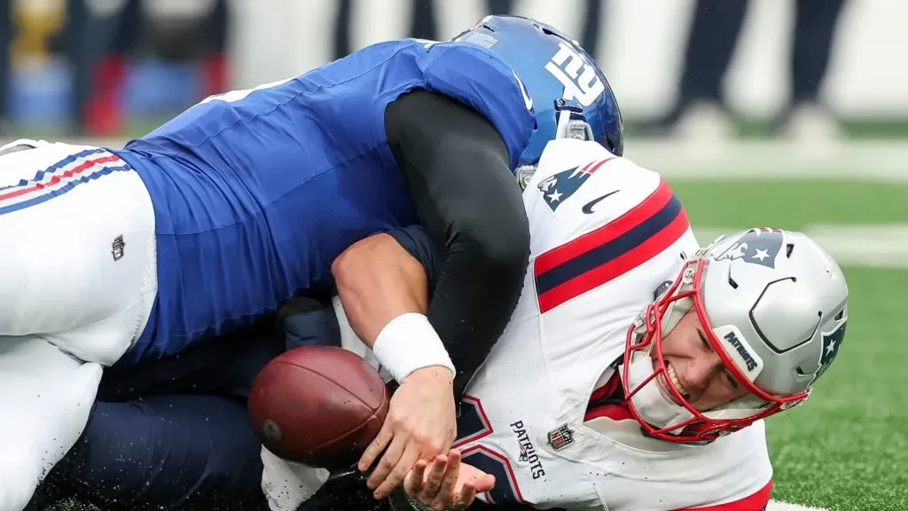Mac Jones fumbles the ball while being tackled by Kayvon Thibodeaux.