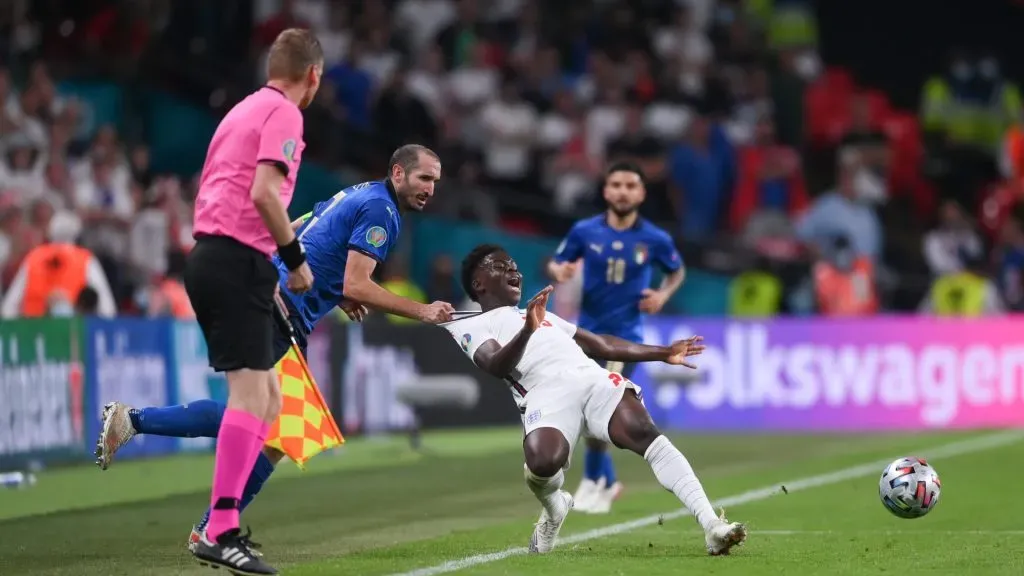 Bukayo Saka of England is fouled by Giorgio Chiellini of Italy during the UEFA Euro 2020 Championship Final between Italy and England at Wembley Stadium on July 11, 2021 in London, England.