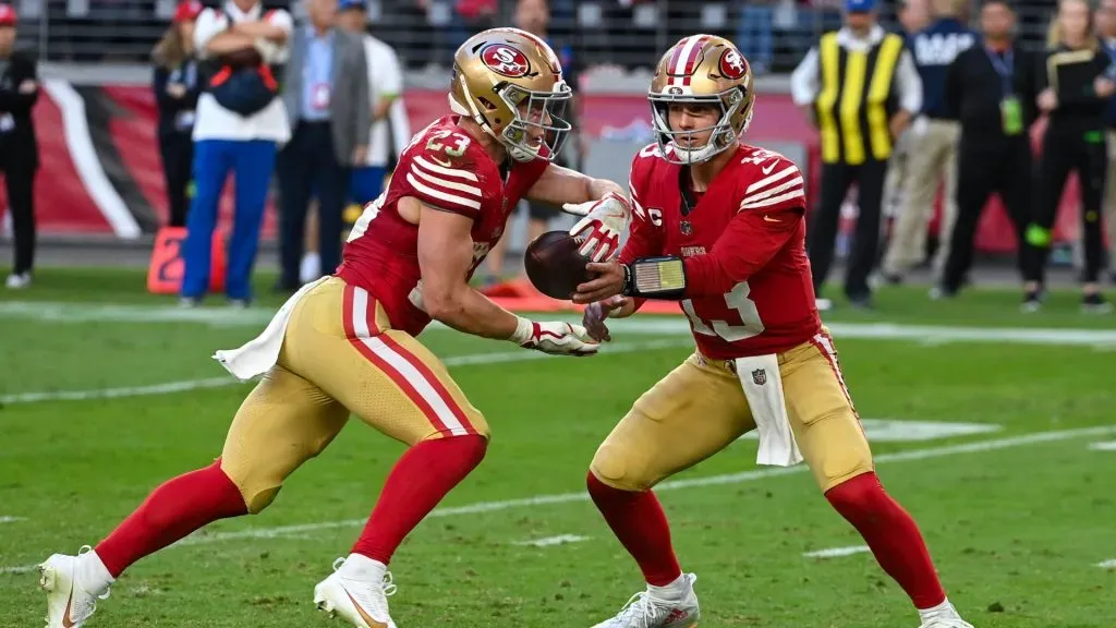Brock Purdy #13 of the San Francisco 49ers hands the ball off to Christian McCaffrey #23 of the San Francisco 49ers during the fourth quarter against the Arizona Cardinals at State Farm Stadium on December 17, 2023 in Glendale, Arizona.