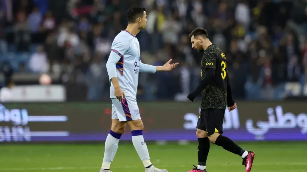 Lionel Messi walks past Cristiano Ronaldo of Riyadh XI after scoring the side’s first goal during the Winter Tour 2023 friendly between Paris Saint-Germain and Riyadh XI at King Fahd International Stadium on January 19, 2023.