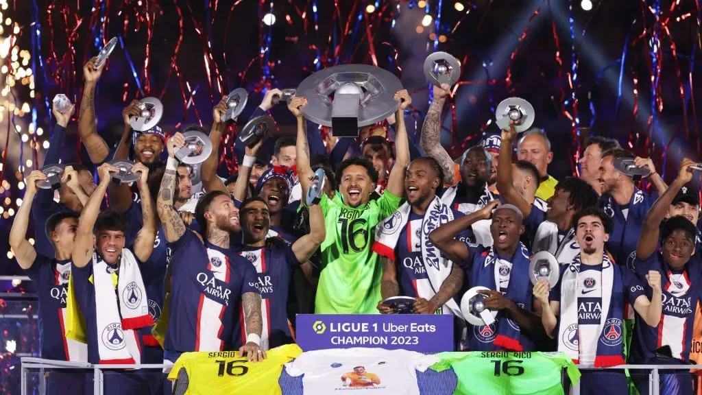 Marquinhos of Paris Saint-Germain, wearing a match shirt featuring the name of Sergio Rico and number 16, lifts the Ligue 1 Uber Eats trophy as players of Paris Saint-Germain celebrate after the Ligue 1 match between Paris Saint-Germain and Clermont Foot at Parc des Princes on June 03, 2023 in Paris, France. (Photo by Julian Finney/Getty Images)