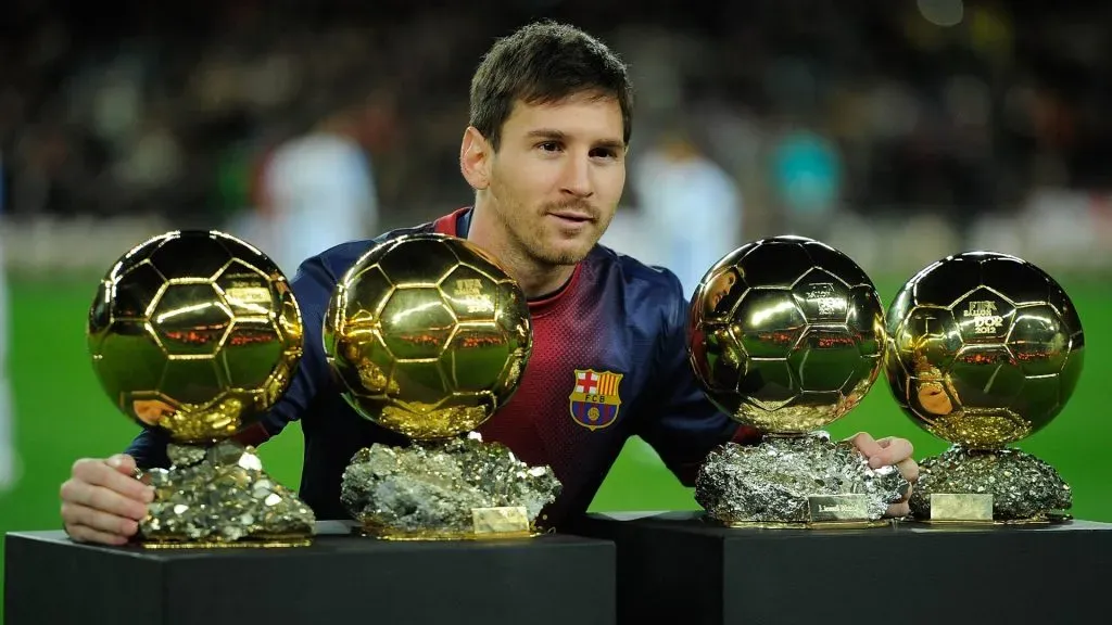 Lionel Messi displaying four Ballon d'Ors in 2013.