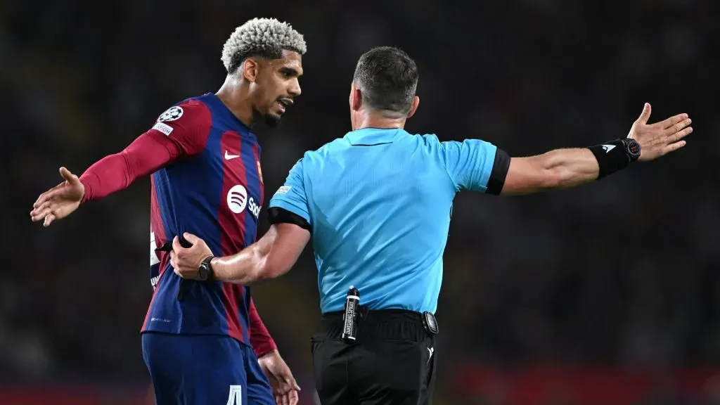 Ronald Araujo of FC Barcelona reacts towards Referee Istvan Kovacs as he is ushered off after being shown a red card following a foul on Bradley Barcola of Paris Saint-Germain (not pictured) during the UEFA Champions League quarter-final second leg match between FC Barcelona and Paris Saint-Germain at Estadi Olimpic Lluis Companys on April 16, 2024 in Barcelona, Spain.