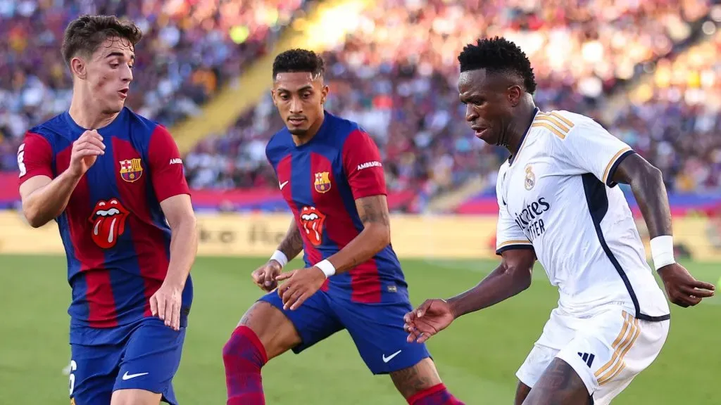 Vinicius Junior of Real Madrid challenges for the ball against Gavi of FC Barcelona during the LaLiga EA Sports match between FC Barcelona and Real Madrid CF at Estadi Olimpic Lluis Companys on October 28, 2023 in Barcelona, Spain.