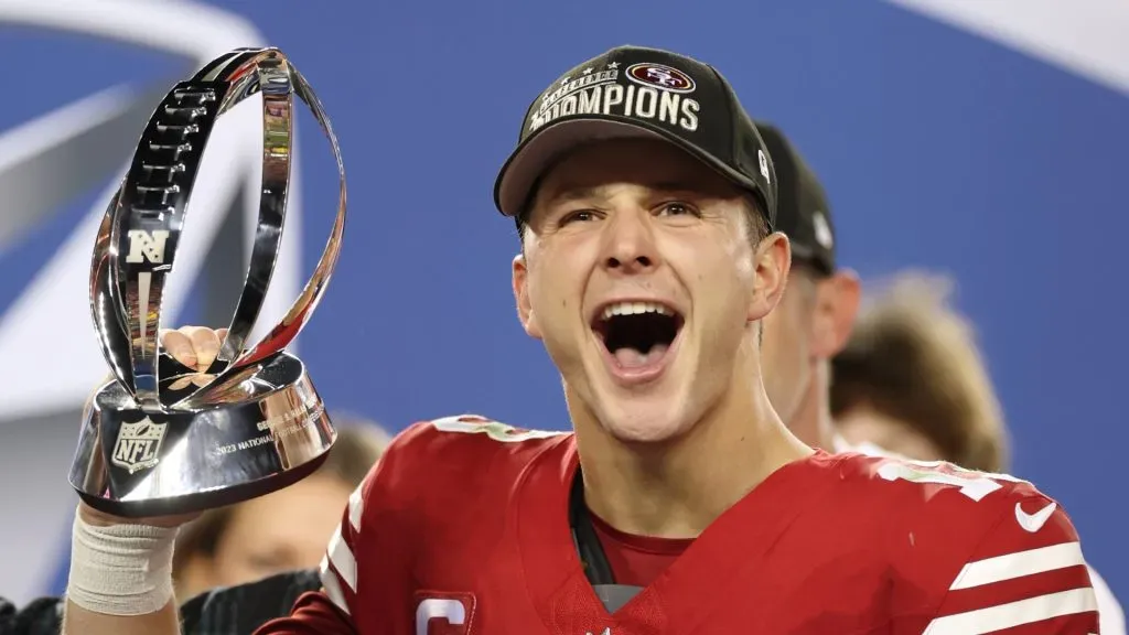 Brock Purdy #13 of the San Francisco 49ers reacts as he holds the George Halas Trophy after defeating the Detroit Lions 34-31 in the NFC Championship Game at Levi’s Stadium on January 28, 2024 in Santa Clara, California.